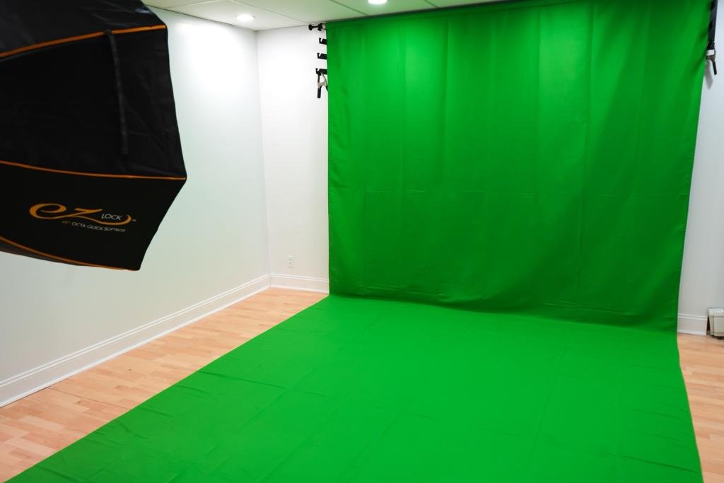 a room with a light and a green screen